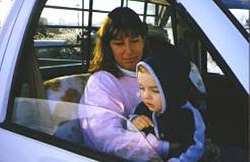 woman and baby sitting in truck