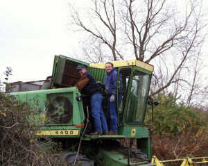 two men working on combine