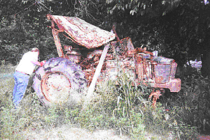 tractor with smashed roof, cowling, and hood