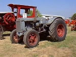 tractor is orange with rounded grill, black badge, narrow front