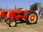 tractor is orange with rounded grill, black badge, narrow front