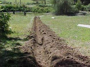 evenly dug trench running to pond in the background